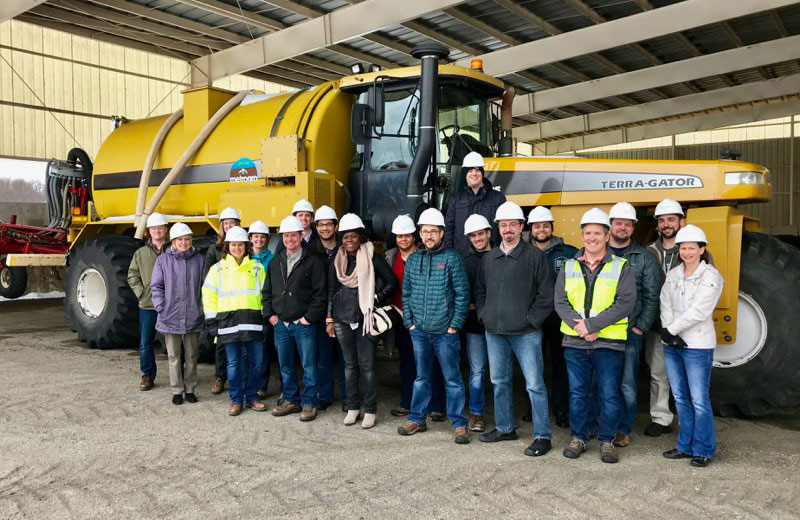 Core employees in front of equipment